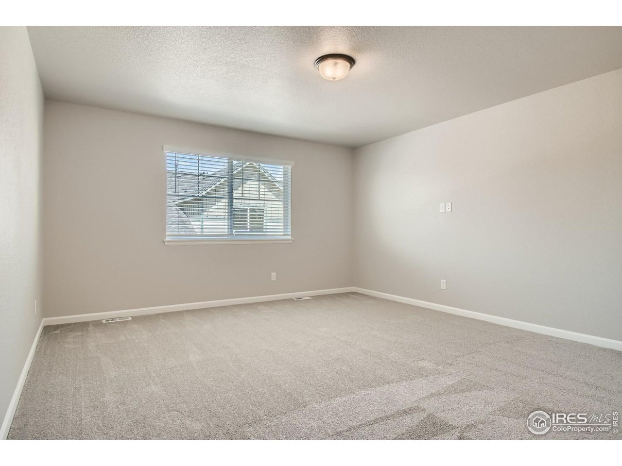 2540 Brookstone Drive, Unit B Milliken, CO 80543 - Photo 15 of 25 an empty room with windows