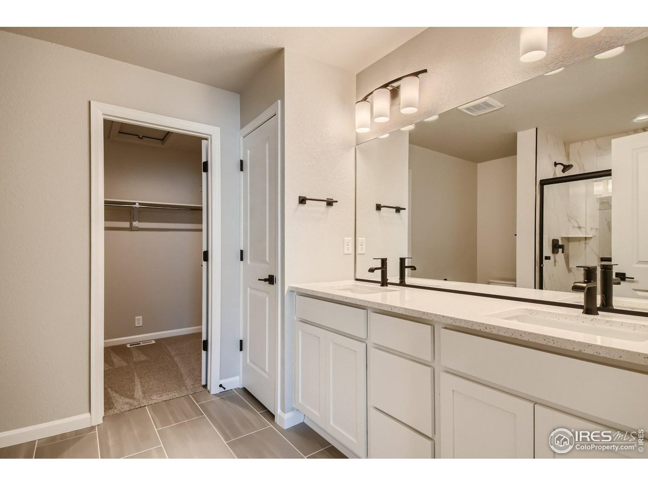 2540 Brookstone Drive, Unit B Milliken, CO 80543 - Photo 16 of 25 a bathroom with a sink and a mirror