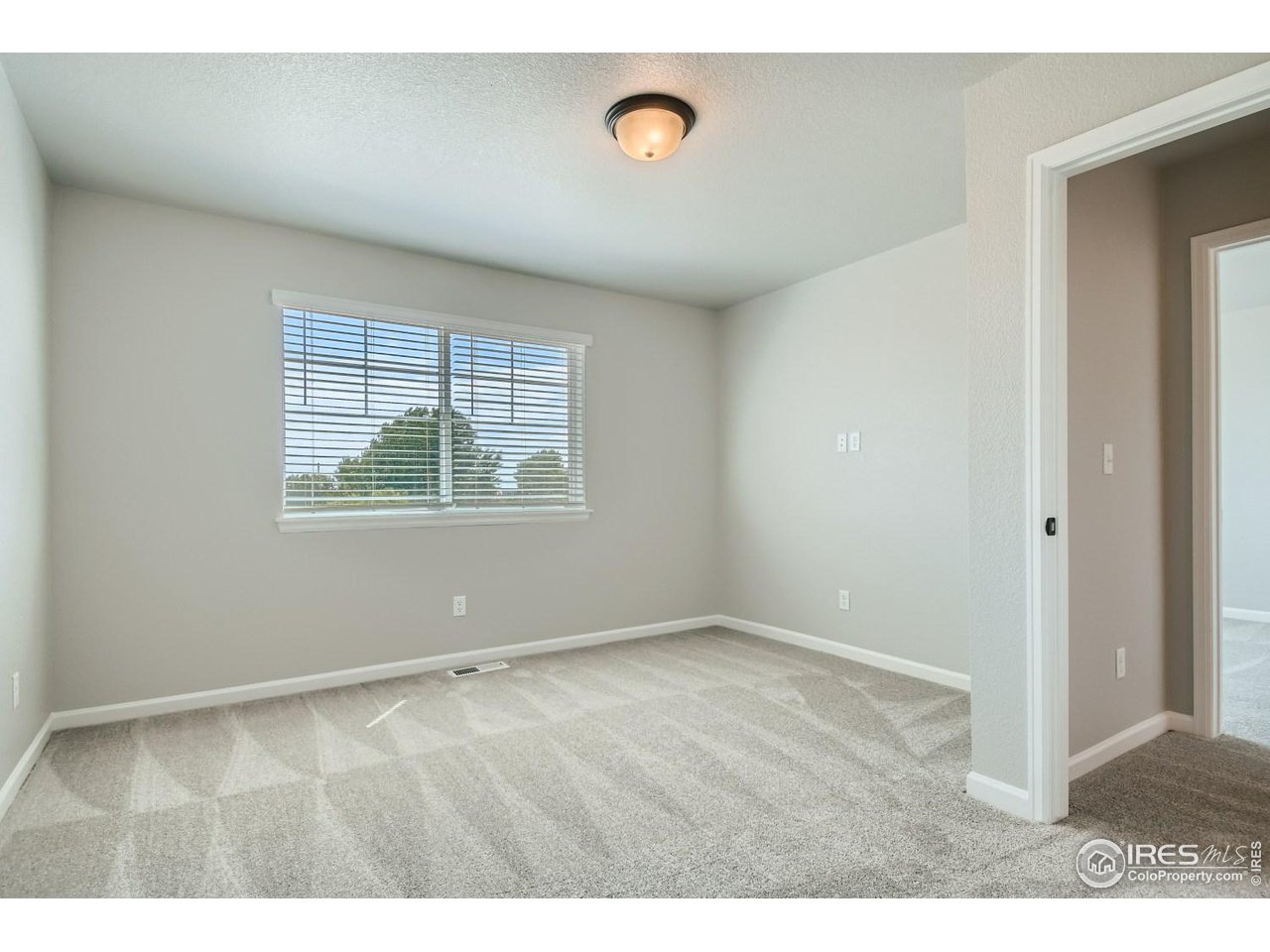 2540 Brookstone Drive, Unit B Milliken, CO 80543 - Photo 20 of 25 a view of an empty room with window