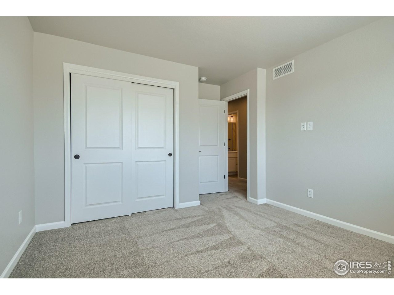 2540 Brookstone Drive, Unit B Milliken, CO 80543 - Photo 23 of 25 an empty room with closet and wooden floor