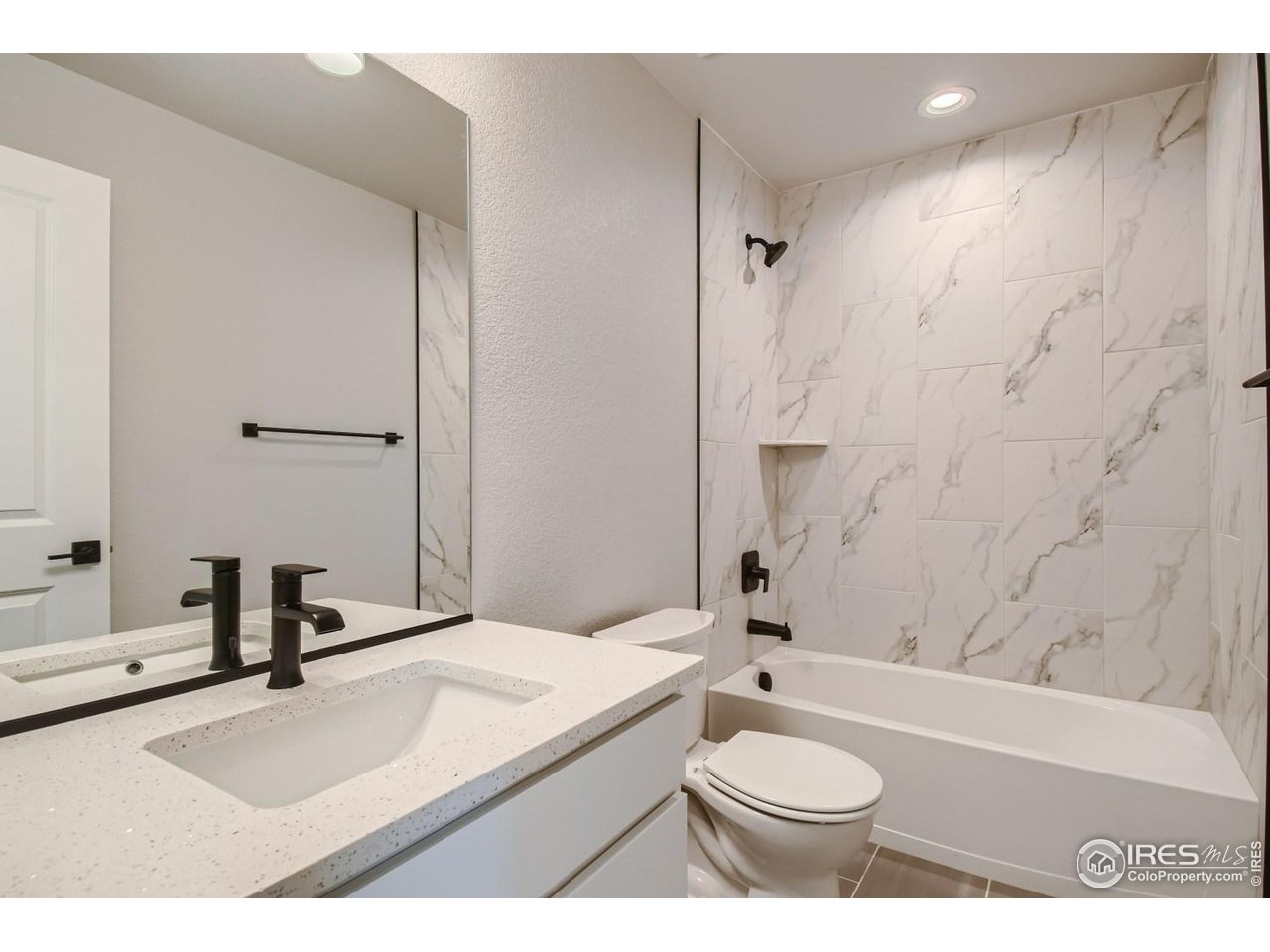 2540 Brookstone Drive, Unit B Milliken, CO 80543 - Photo 24 of 25 a bathroom with a sink a toilet and shower