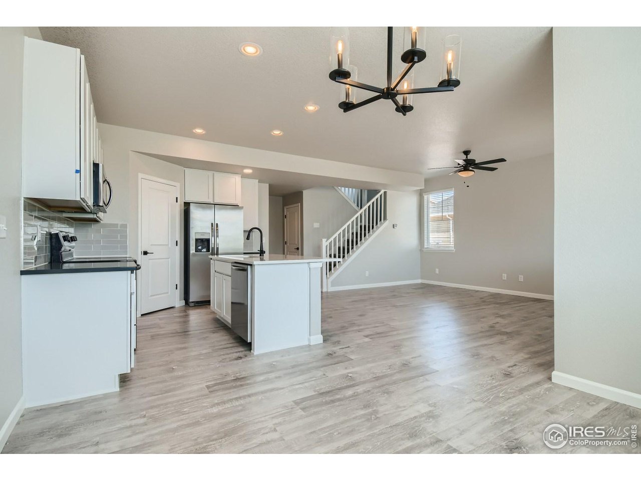 2540 Brookstone Drive, Unit B Milliken, CO 80543 - Photo 5 of 25 a view of a kitchen with a sink and refrigerator