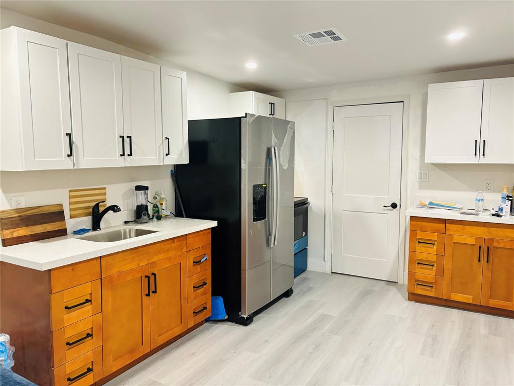 1116 West 32nd Street Riviera Beach, FL 33404 - Photo 2 of 12 a kitchen with stainless steel appliances granite countertop a refrigerator sink and cabinets