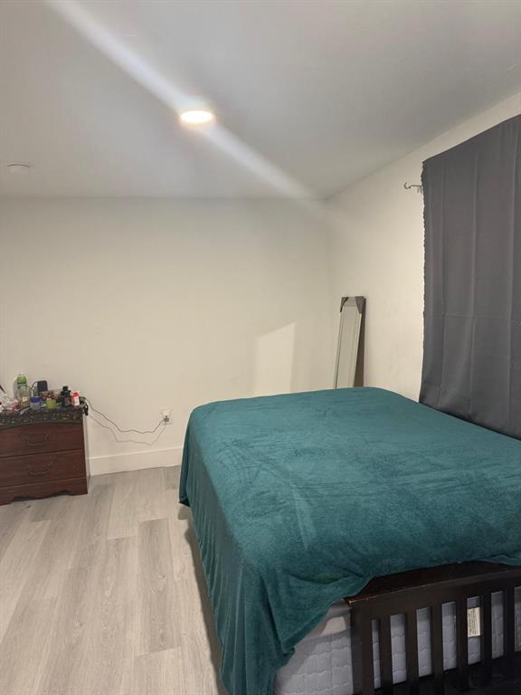 1116 West 32nd Street Riviera Beach, FL 33404 - Photo 6 of 12 a bedroom with a bed and a dresser