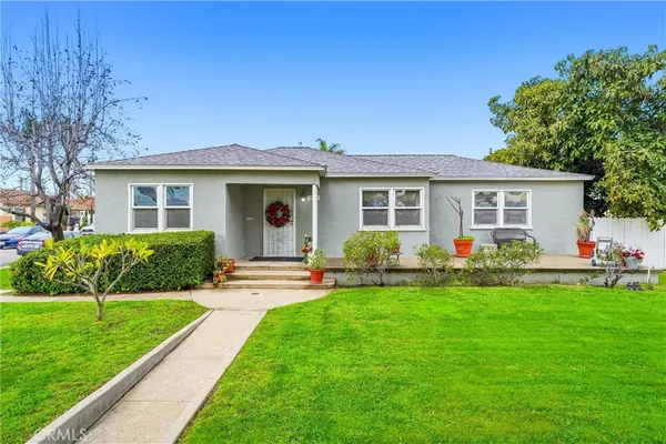 a front view of house with a garden and patio