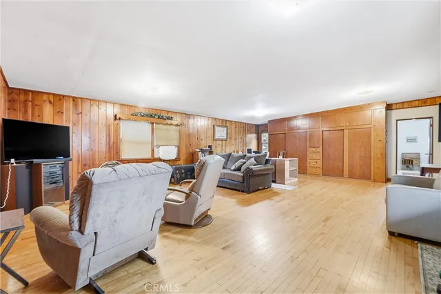a living room with furniture a flat screen tv and a large window