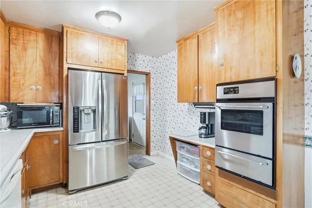 a kitchen with stainless steel appliances a refrigerator and a stove