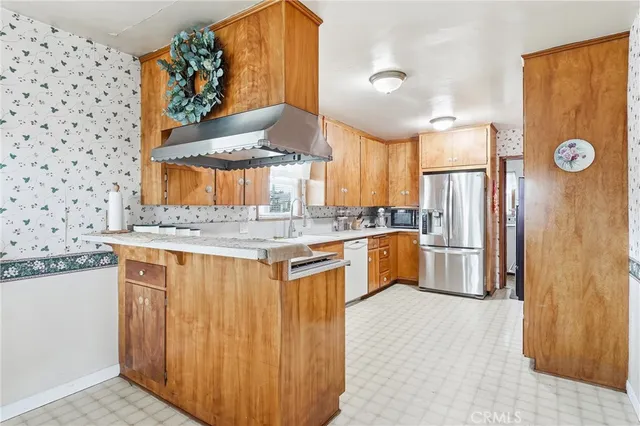 a kitchen with granite countertop a sink stainless steel appliances and cabinets