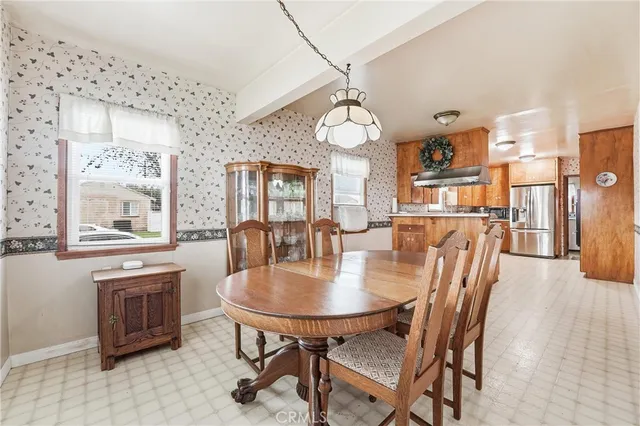 a view of a dining room with furniture and a chandelier