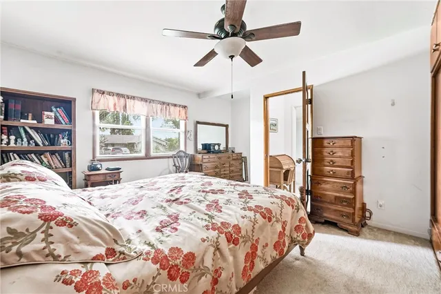 a bedroom with a bed dresser and a window