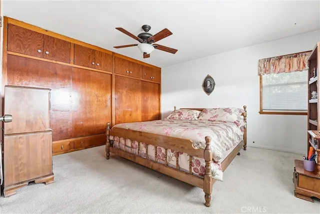 a bedroom with a bed and a painting on the wall