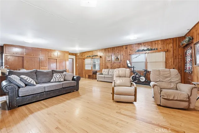 a living room with furniture window and a wooden floor