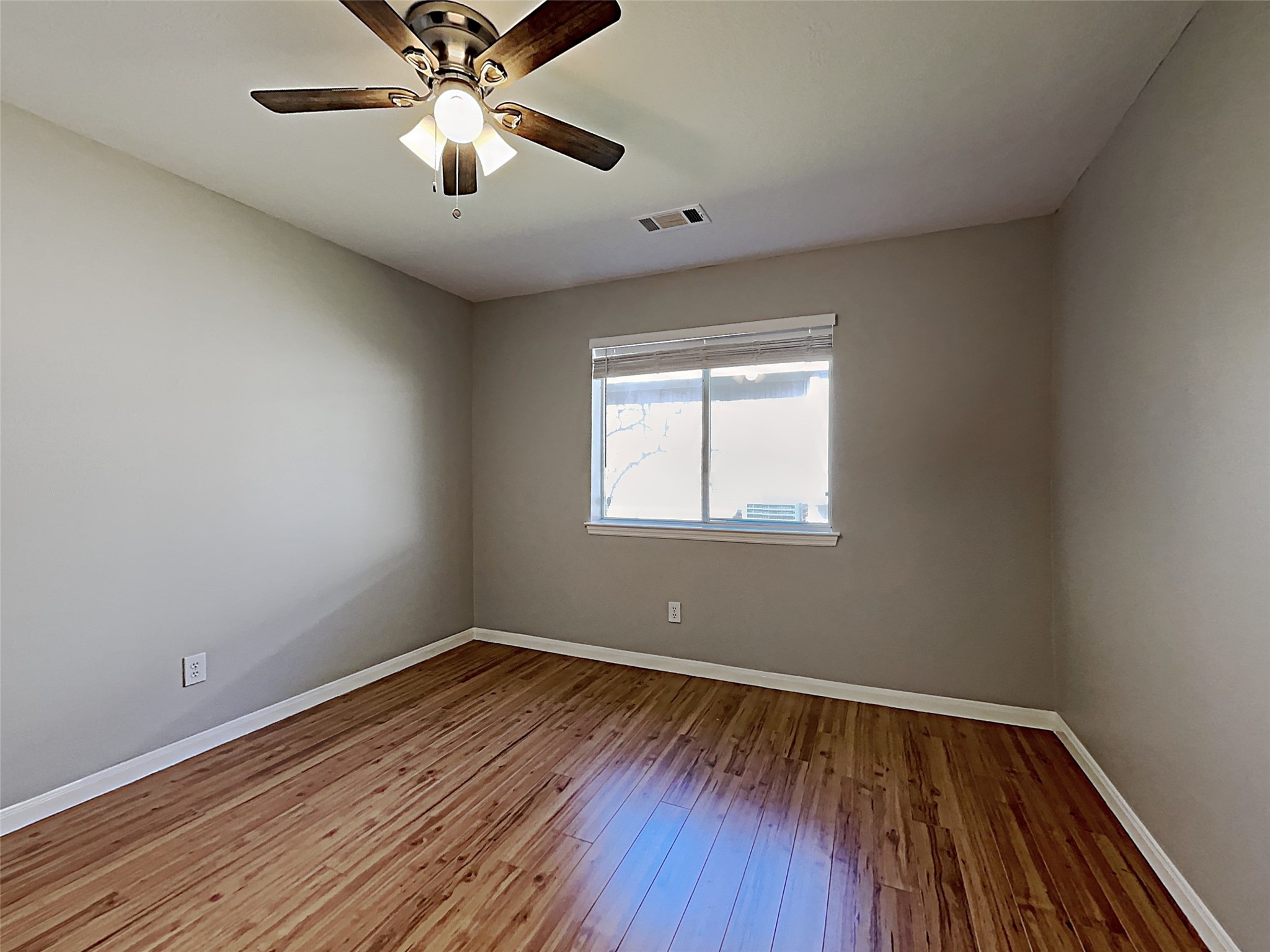 85 Summer Lark Place Spring, TX 77382 - Photo 3 of 21 a view of empty room with wooden floor and fan