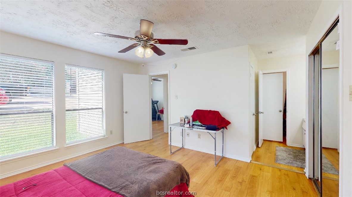 1005 Spring Loop, Unit D College Station, TX 77840 - Photo 16 of 25 a bedroom with a bed dresser and a window