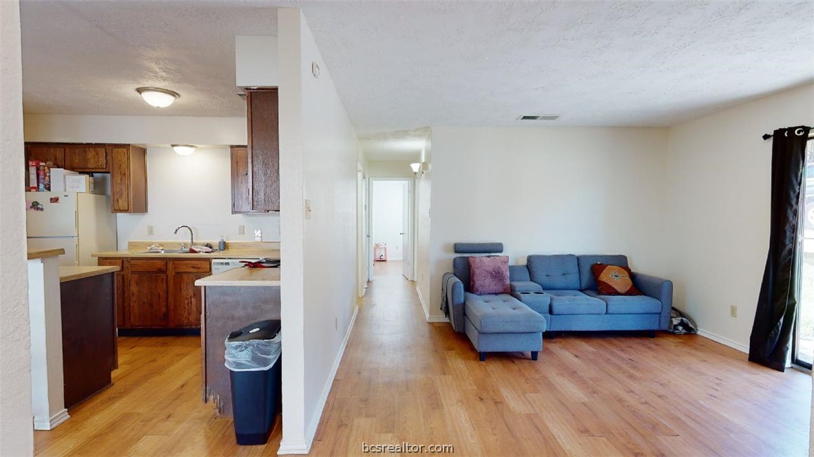 1005 Spring Loop, Unit D College Station, TX 77840 - Photo 3 of 25 a living room with furniture and kitchen view