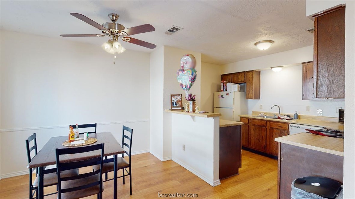 1005 Spring Loop, Unit D College Station, TX 77840 - Photo 6 of 25 a kitchen with a table and chairs in it