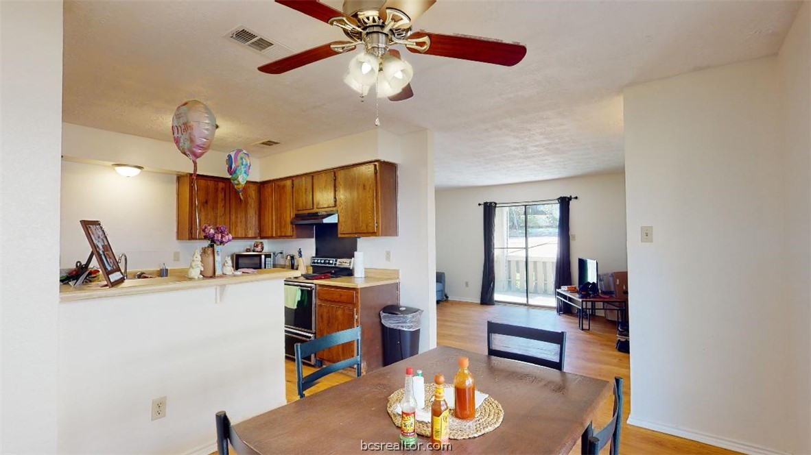1005 Spring Loop, Unit D College Station, TX 77840 - Photo 7 of 25 a view of a dining room with furniture and a chandelier