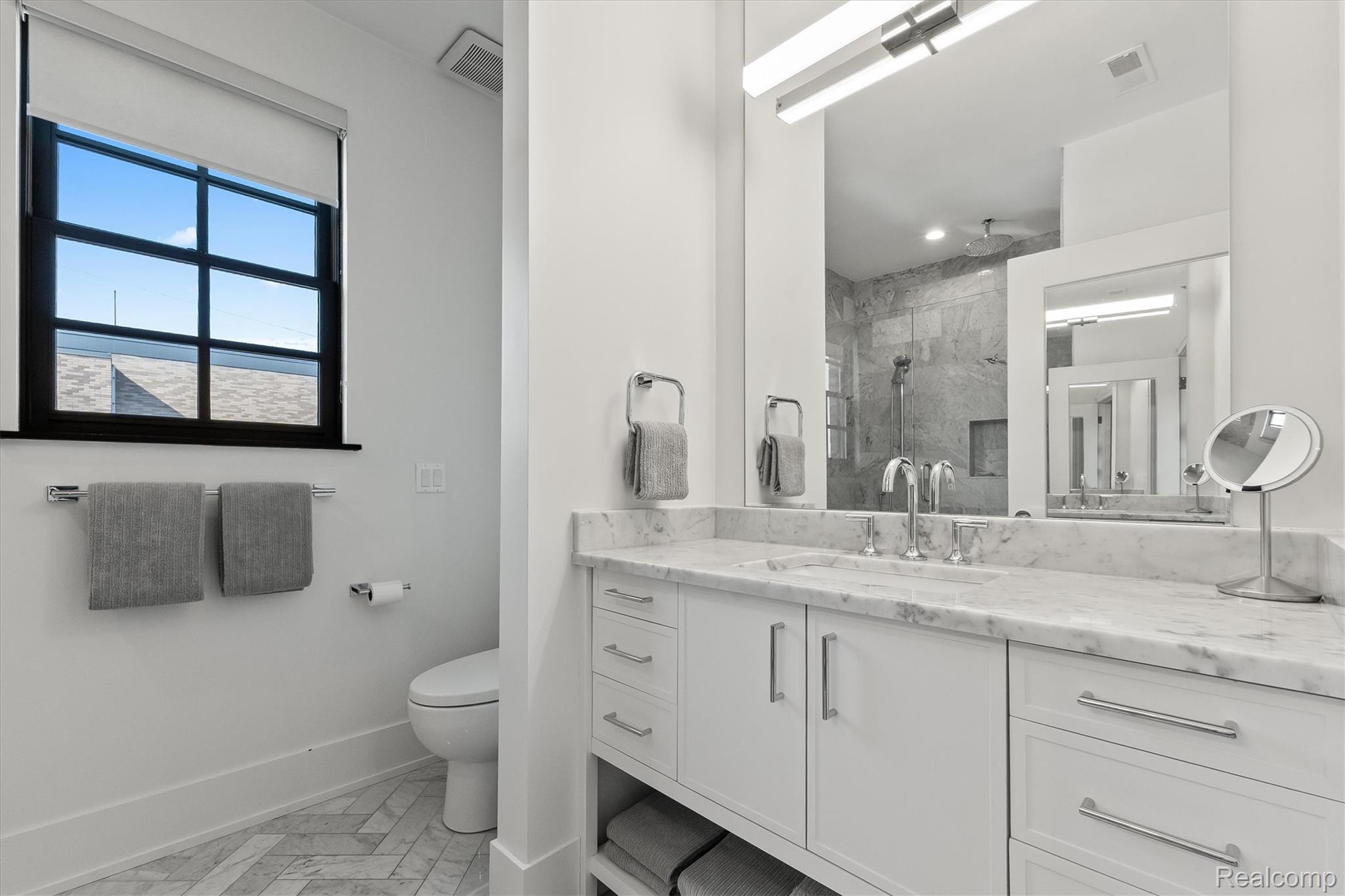 936 West Eleven Mile Road Royal Oak, MI 48067 - Photo 9 of 19 Bathroom featuring vanity and a marble finish shower