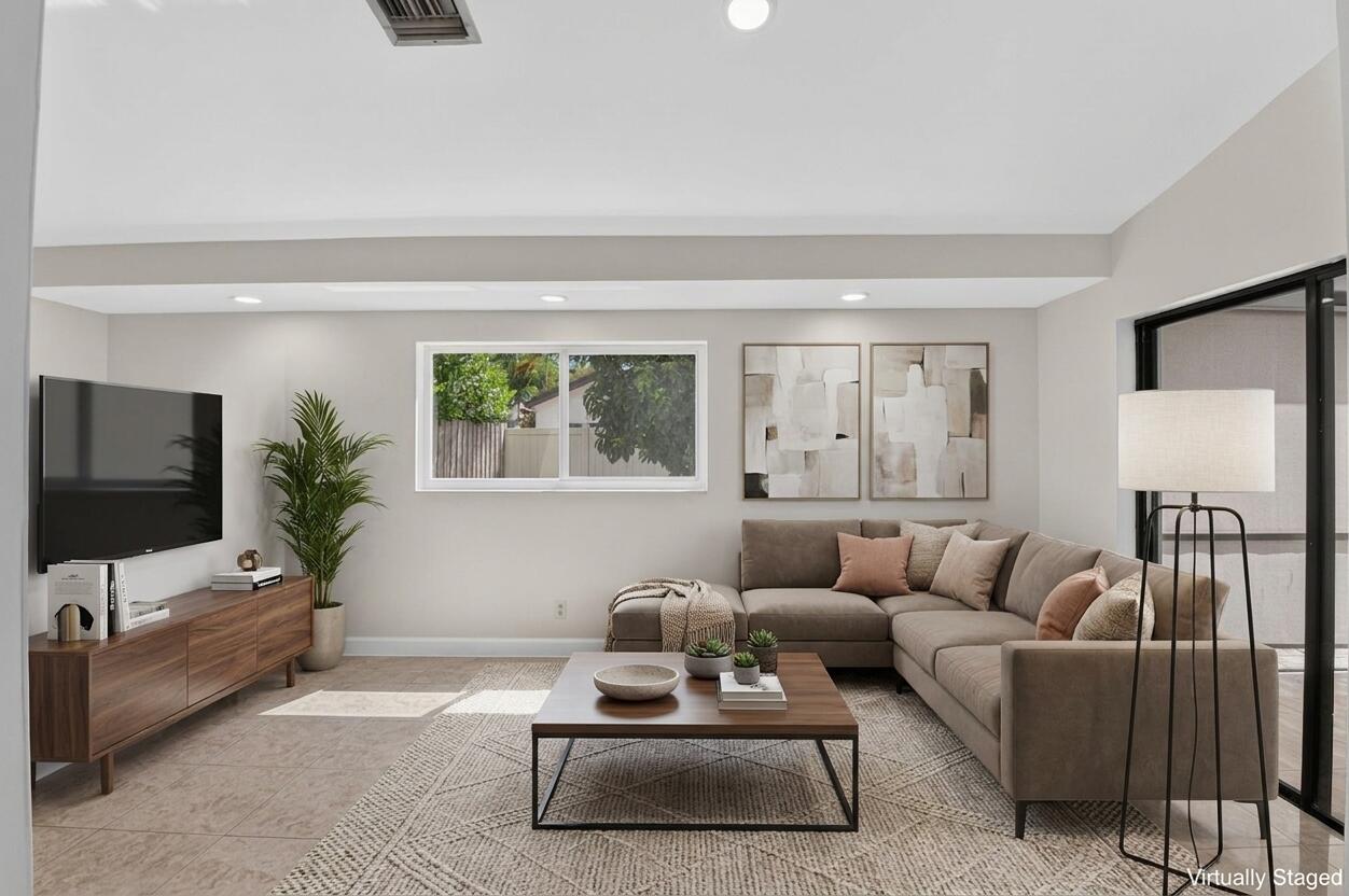 21070 Woodspring Avenue Boca Raton, FL 33428 - Photo 13 of 30 a living room with furniture and a flat screen tv