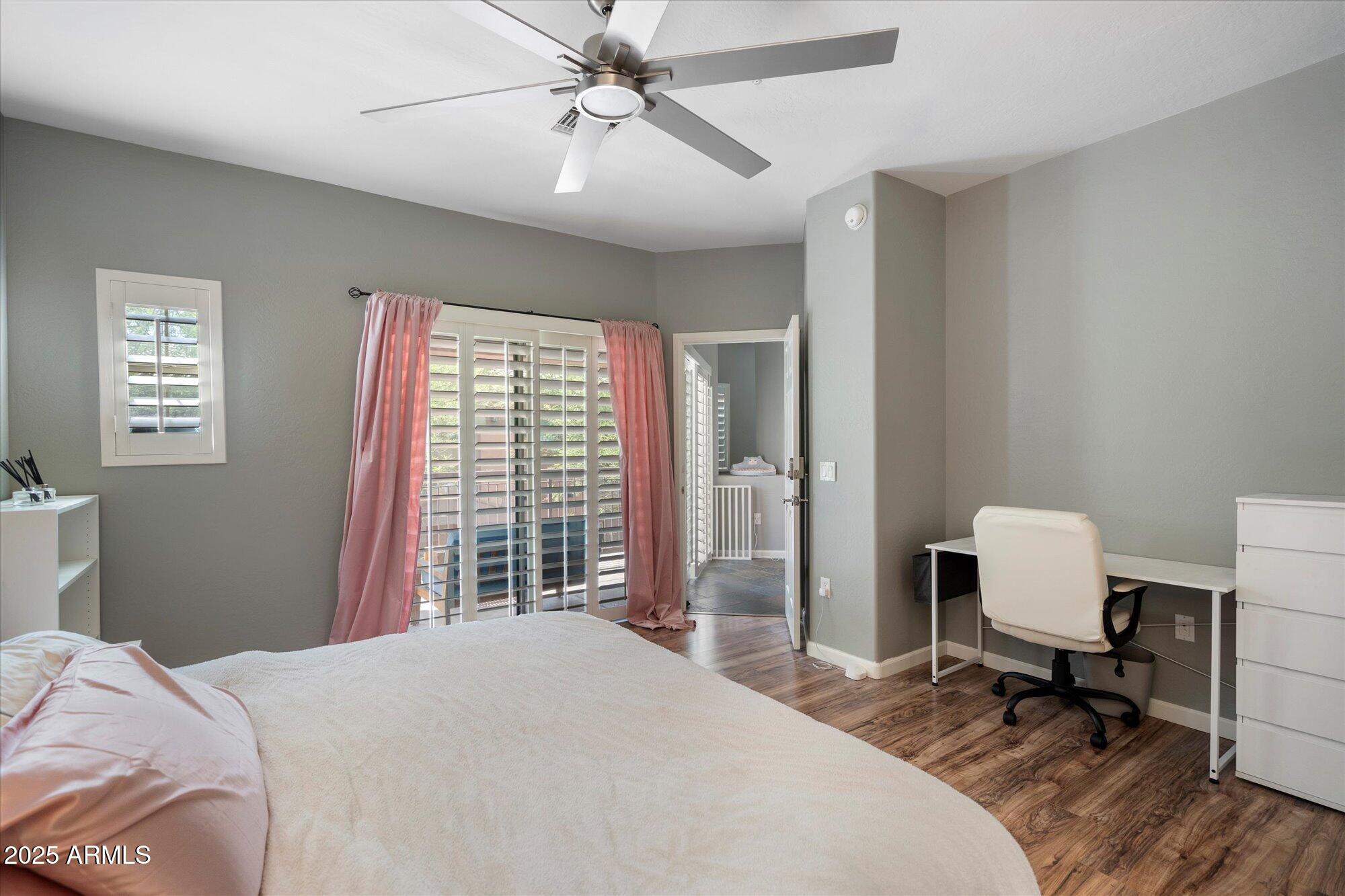 3935 East Rough Rider Road, Unit 1164 Phoenix, AZ 85050 - Photo 12 of 20 a bedroom with a bed and a window