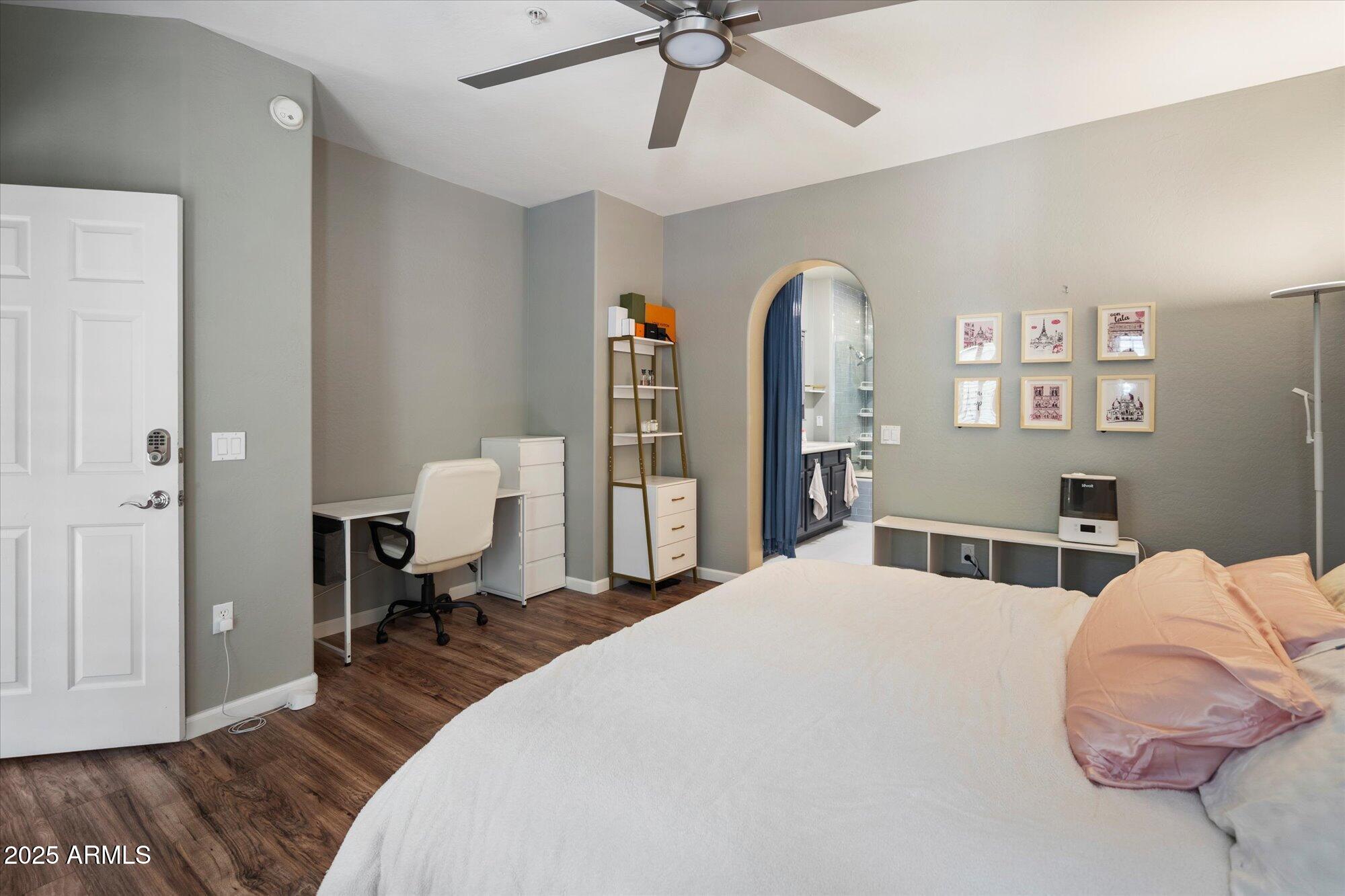 3935 East Rough Rider Road, Unit 1164 Phoenix, AZ 85050 - Photo 13 of 20 a bedroom with a bed and a chandelier