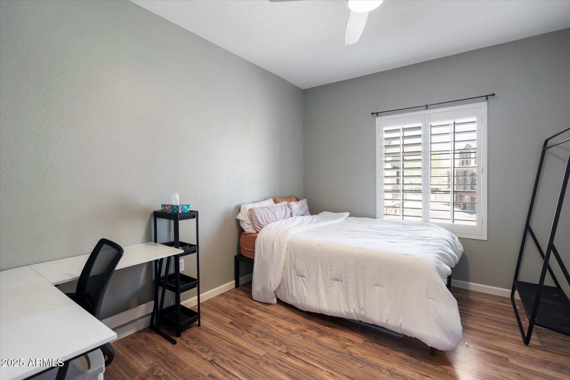 3935 East Rough Rider Road, Unit 1164 Phoenix, AZ 85050 - Photo 15 of 20 a bedroom with a bed and a window