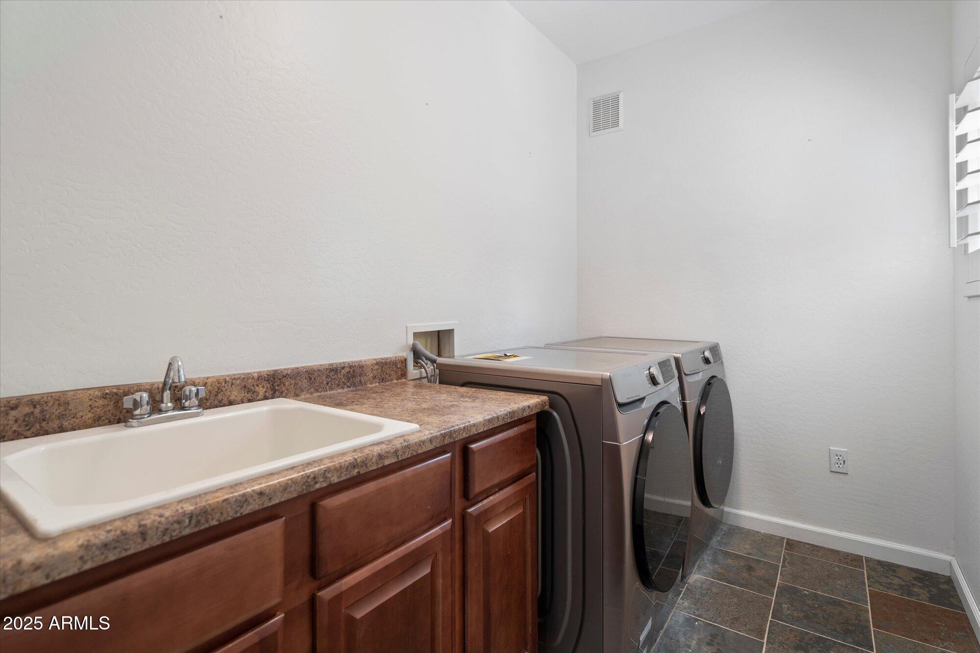 3935 East Rough Rider Road, Unit 1164 Phoenix, AZ 85050 - Photo 19 of 20 a bathroom with a sink and a mirror
