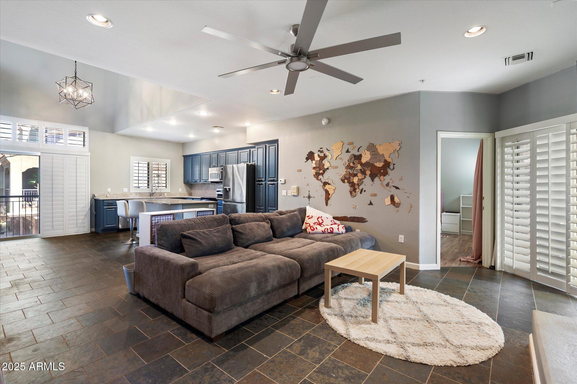 3935 East Rough Rider Road, Unit 1164 Phoenix, AZ 85050 - Photo 3 of 20 a living room with furniture and a view of kitchen