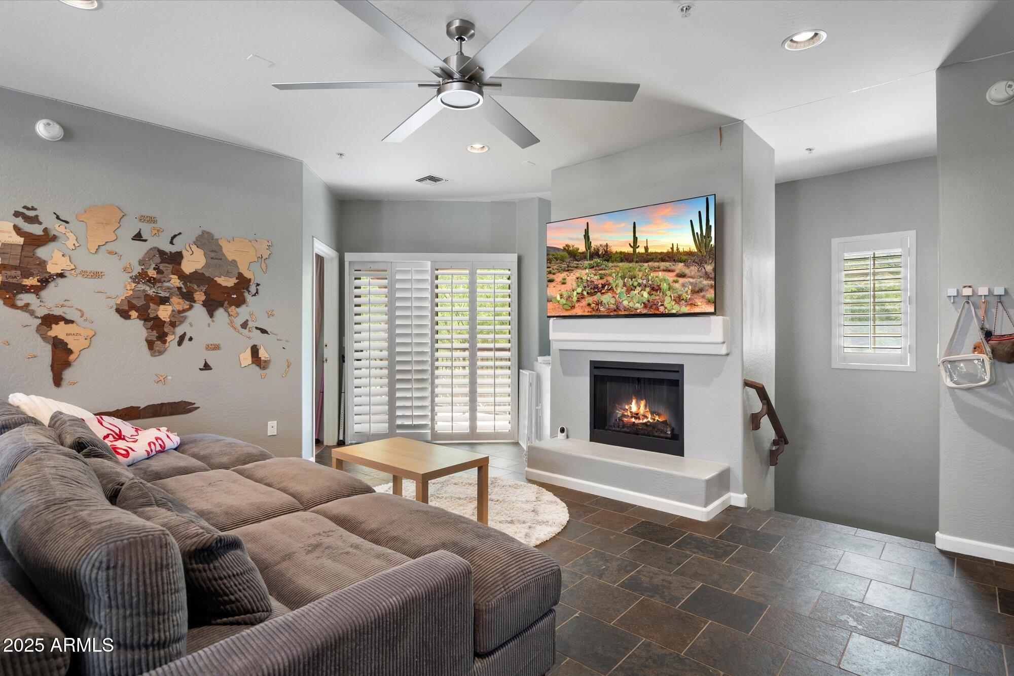 3935 East Rough Rider Road, Unit 1164 Phoenix, AZ 85050 - Photo 4 of 20 a living room with furniture and a fireplace