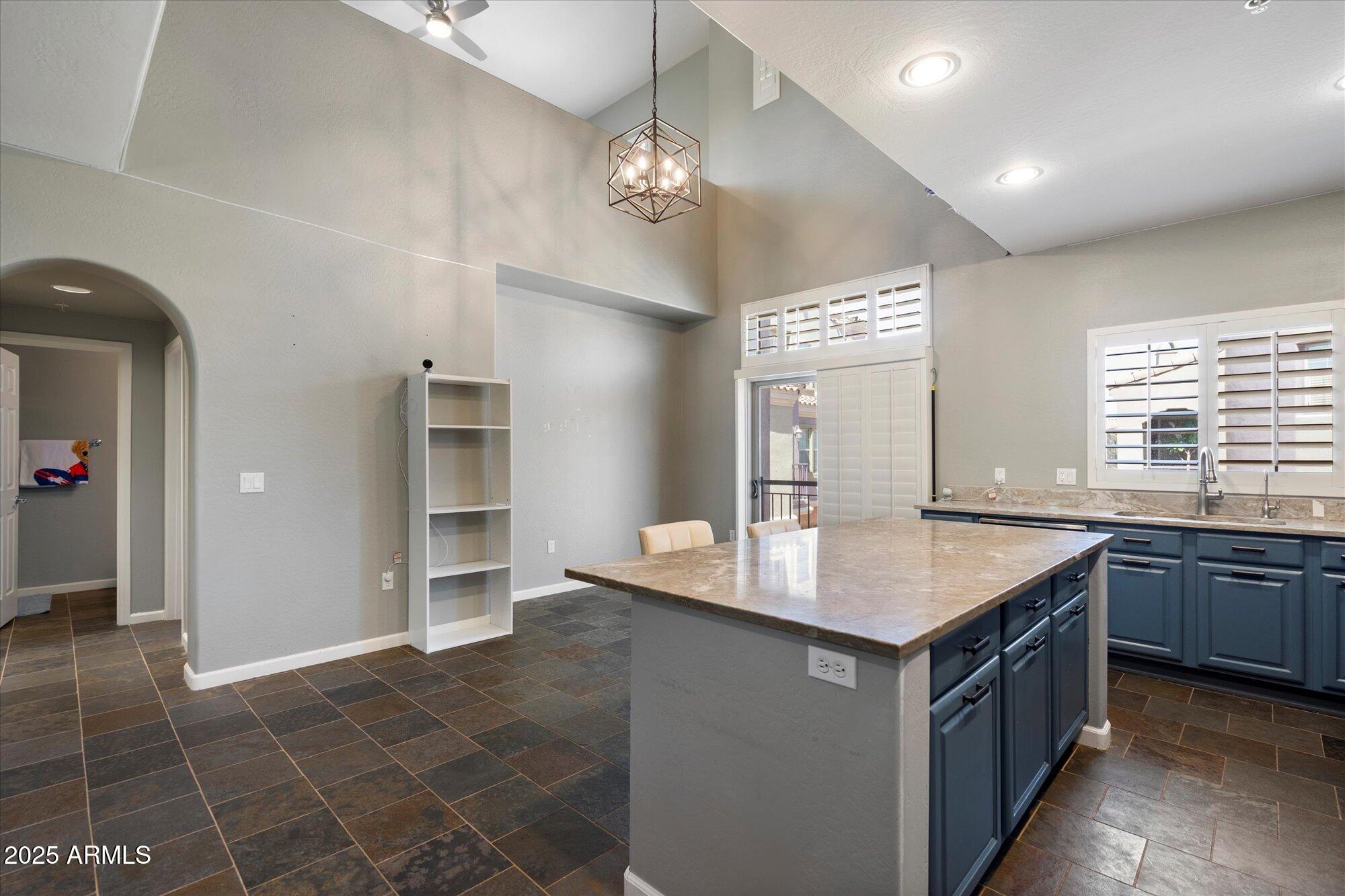 3935 East Rough Rider Road, Unit 1164 Phoenix, AZ 85050 - Photo 9 of 20 a kitchen with a sink cabinets and window