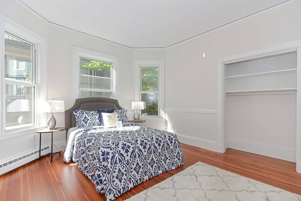 28 Inman Street, Unit 2 Cambridge, MA 02139 - Photo 11 of 24 a bedroom with a bed and wooden floor