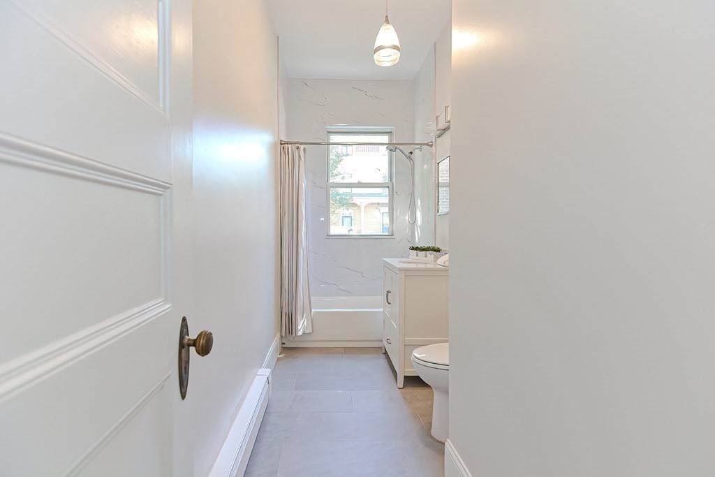 28 Inman Street, Unit 2 Cambridge, MA 02139 - Photo 13 of 24 a bathroom with a sink a toilet and shower