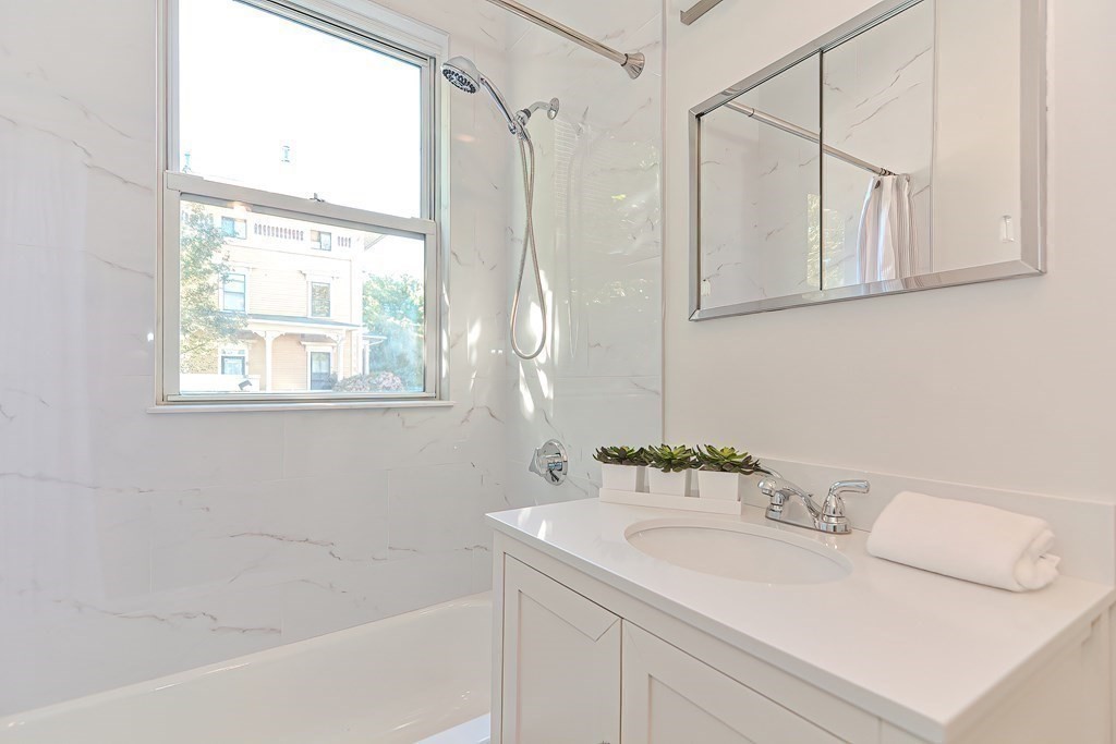 28 Inman Street, Unit 2 Cambridge, MA 02139 - Photo 14 of 24 a bathroom with a sink and a mirror
