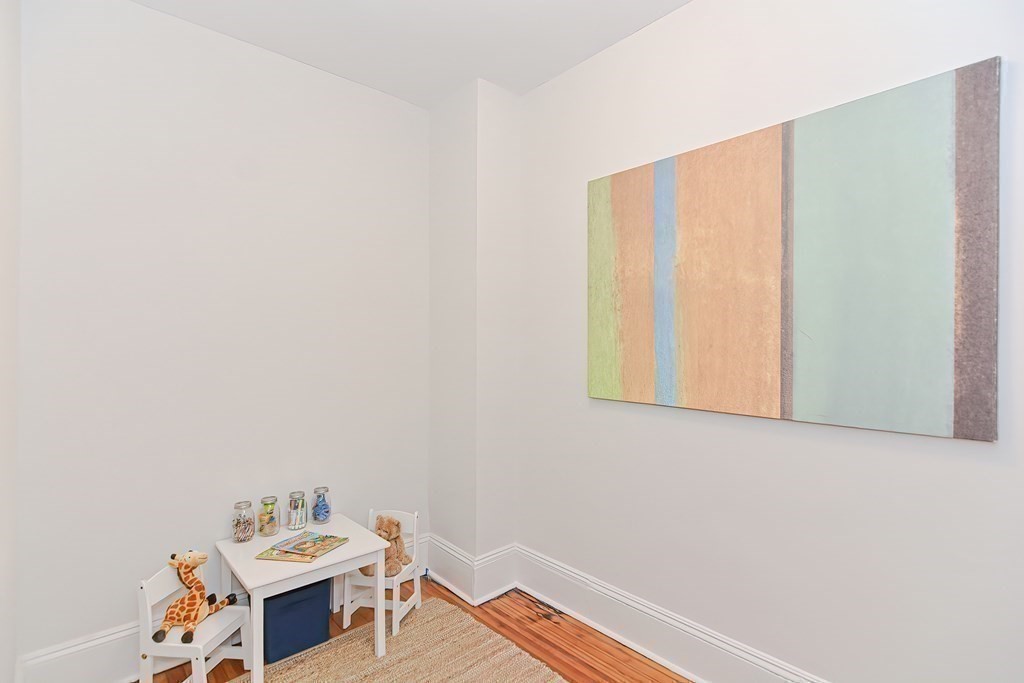 28 Inman Street, Unit 2 Cambridge, MA 02139 - Photo 19 of 24 a room with a bed and wooden floor