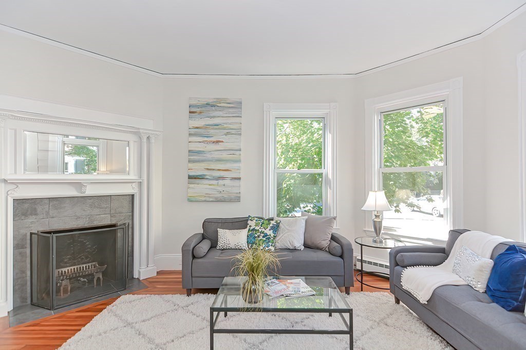 28 Inman Street, Unit 2 Cambridge, MA 02139 - Photo 2 of 24 a living room with furniture and a fireplace