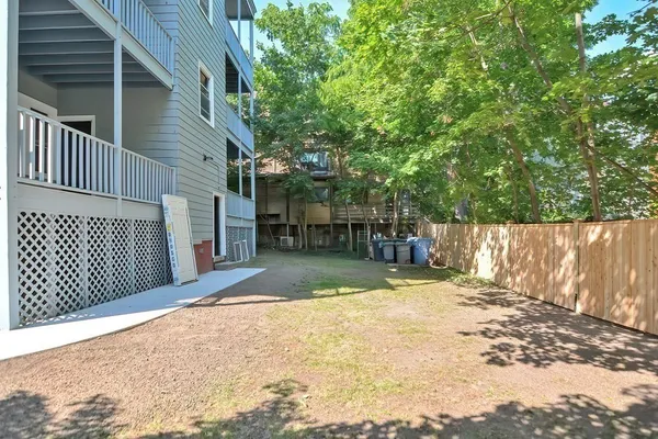 a view of a backyard with wooden fence