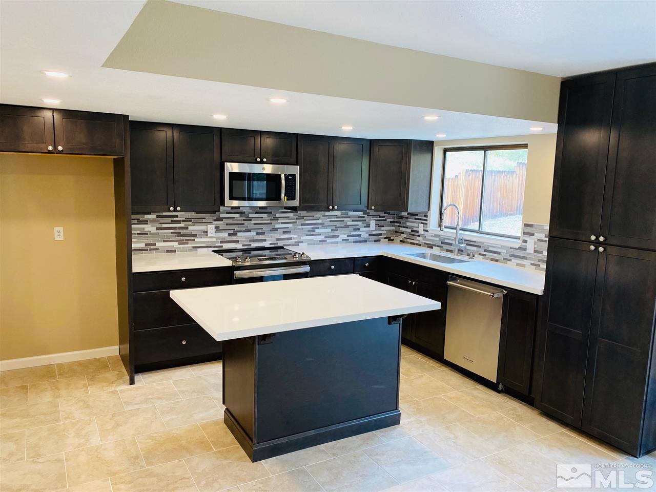 3899 Allen Glen Drive Reno, NV 89503 - Photo 4 of 13 a kitchen with stainless steel appliances kitchen island a cabinets counter space and stainless steel appliances