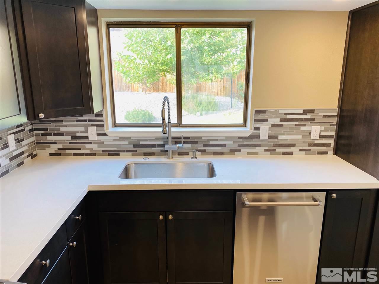 3899 Allen Glen Drive Reno, NV 89503 - Photo 5 of 13 a kitchen with a sink a counter and a window