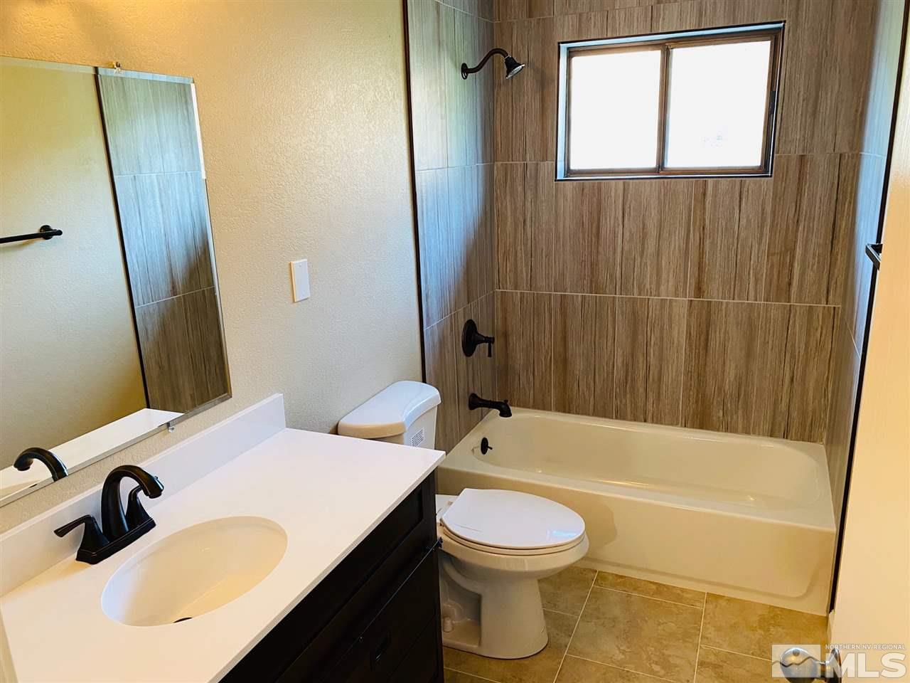 3899 Allen Glen Drive Reno, NV 89503 - Photo 8 of 13 a bathroom with a sink and a mirror