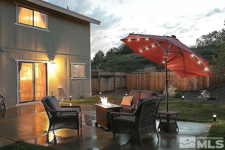 3899 Allen Glen Drive Reno, NV 89503 - Photo 10 of 13 a view of a patio with table and chairs potted plants with wooden floor