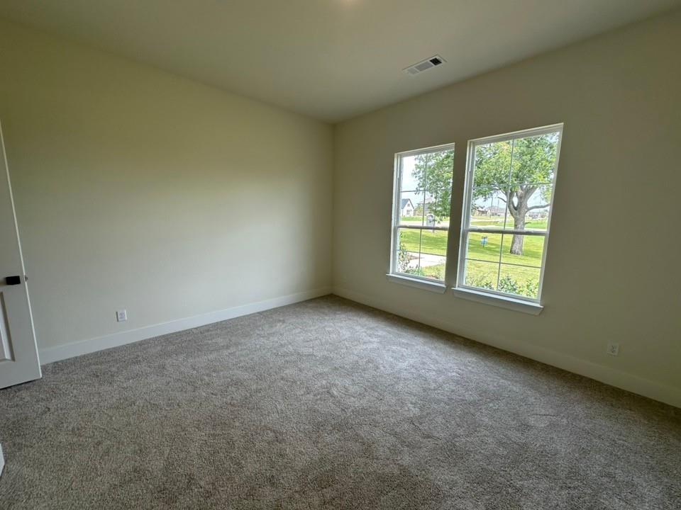 205 Cobb Road Leonard, TX 75452 - Photo 7 of 23 Neutral-toned carpeting grounds this space, complemented by light-colored walls and white trim