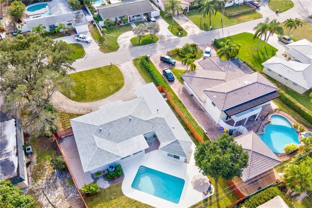 an aerial view of residential house with outdoor space and swimming pool
