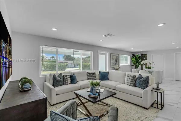 a living room with furniture and a potted plant