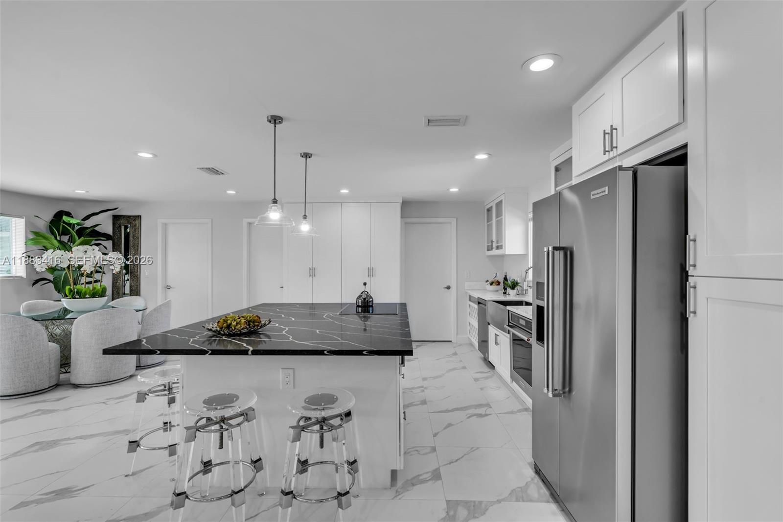 465 Northwest 11th Street Boca Raton, FL 33432 - Photo 12 of 50 a kitchen with a refrigerator a stove and a sink
