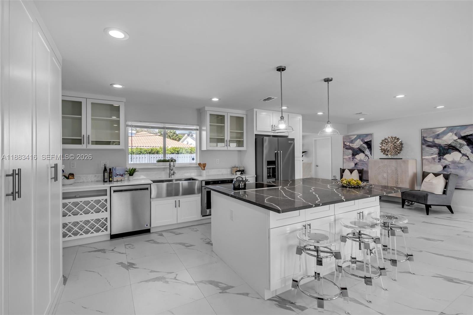 465 Northwest 11th Street Boca Raton, FL 33432 - Photo 13 of 50 a kitchen with stainless steel appliances kitchen island granite countertop a sink and cabinets
