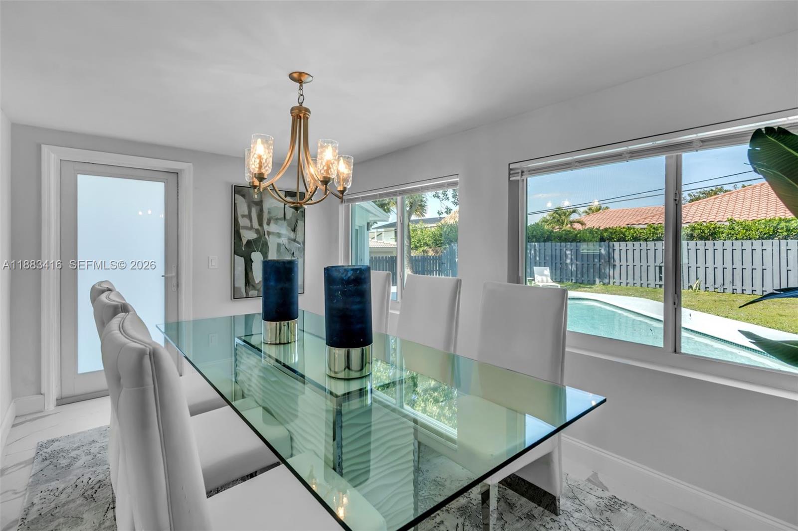 465 Northwest 11th Street Boca Raton, FL 33432 - Photo 15 of 50 a dining room with furniture a chandelier and wooden floor