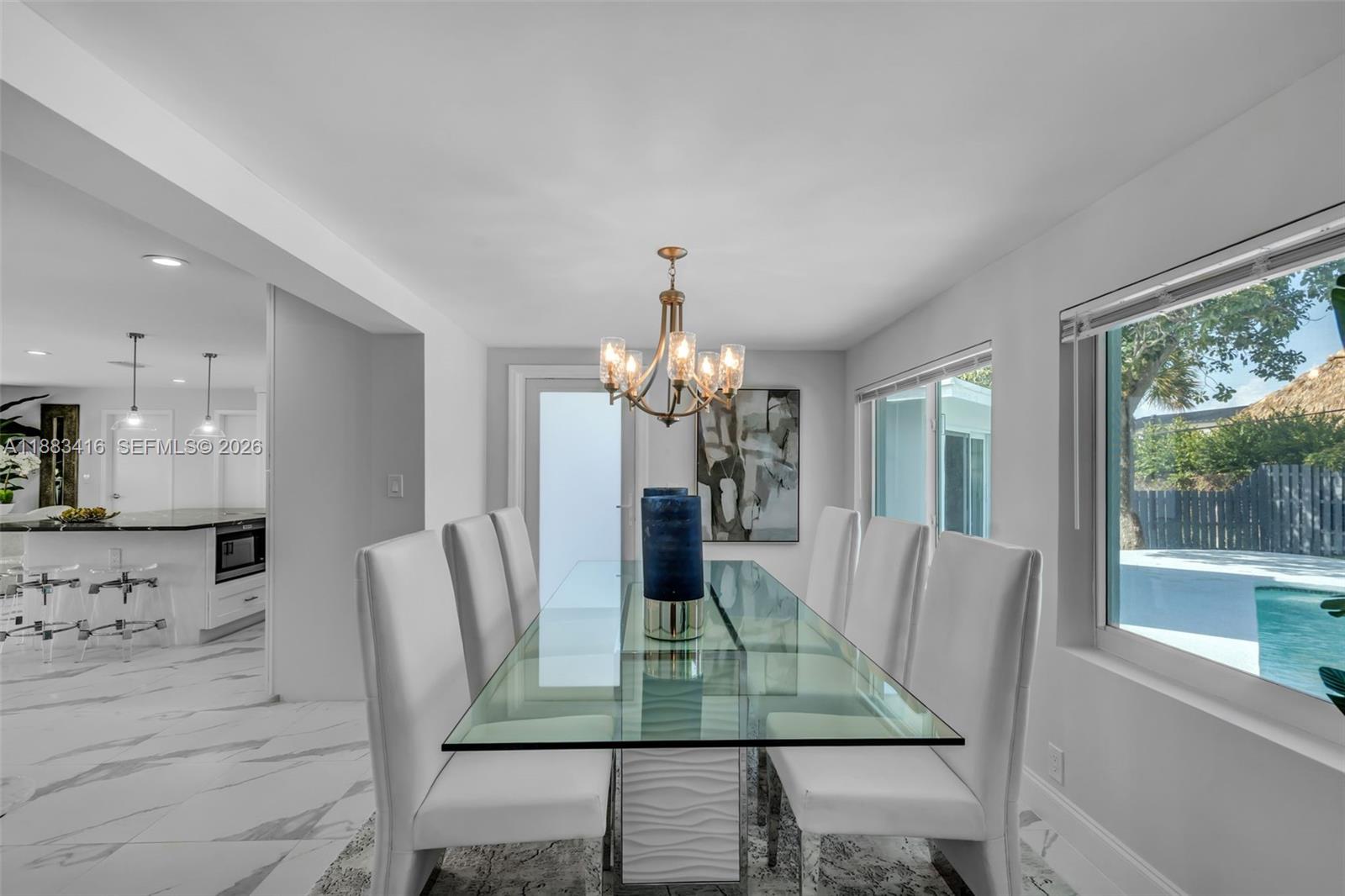 465 Northwest 11th Street Boca Raton, FL 33432 - Photo 16 of 50 a dining room with furniture a large window and wooden floor