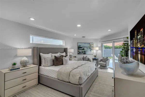 a bedroom with a large bed and a large window