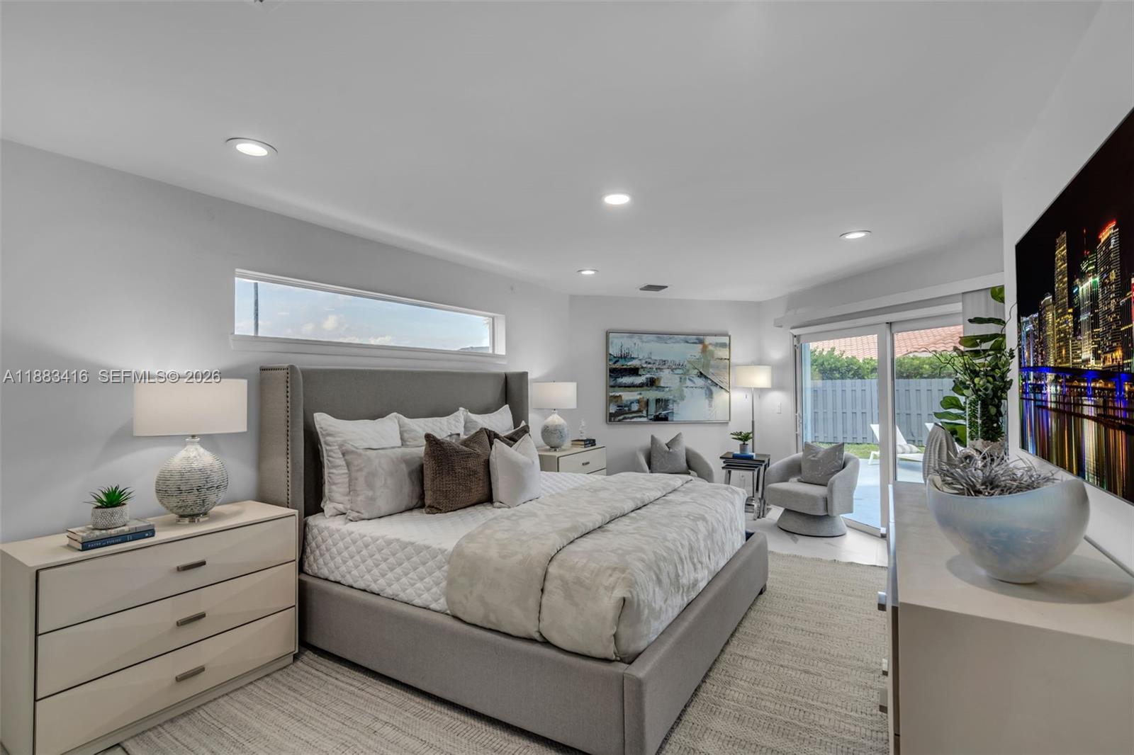 465 Northwest 11th Street Boca Raton, FL 33432 - Photo 20 of 50 a bedroom with a large bed and a large window