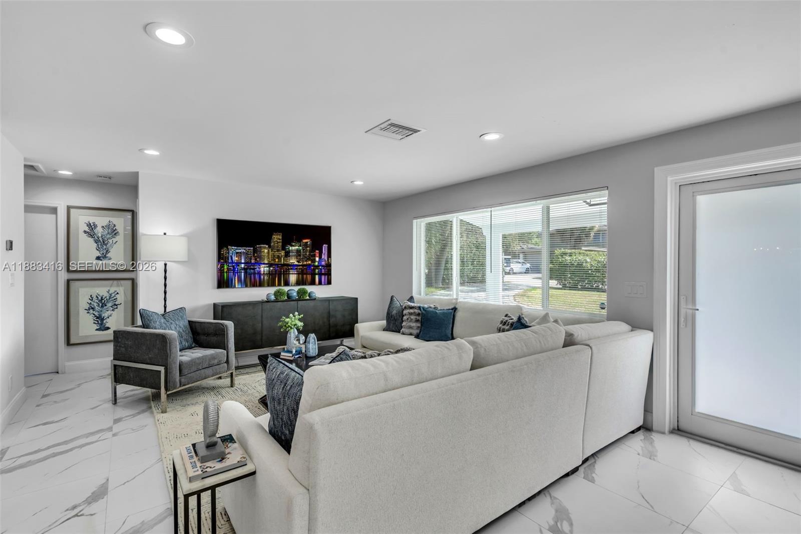 465 Northwest 11th Street Boca Raton, FL 33432 - Photo 2 of 50 a living room with furniture and a flat screen tv
